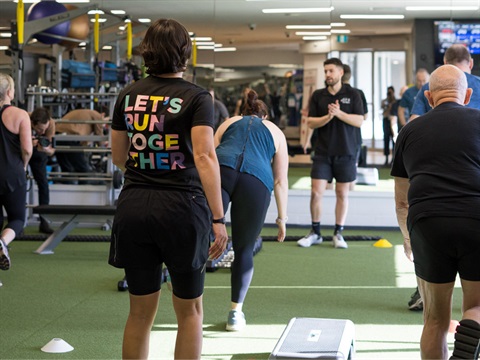 Instructor leading HIIT class in gym