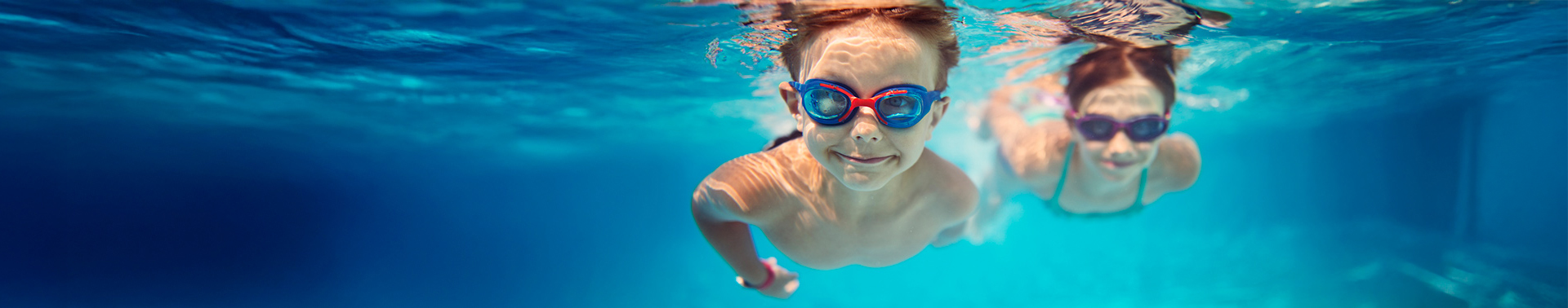 Kids swimming with goggles on